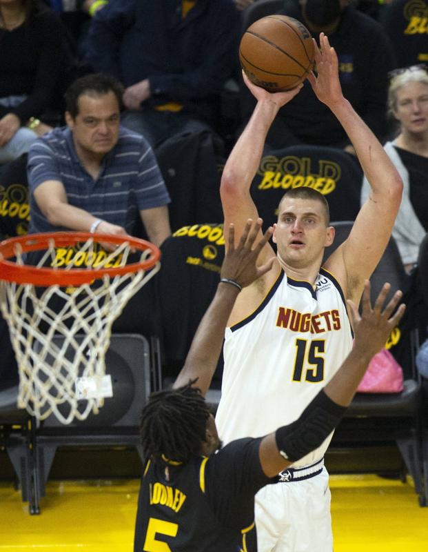 Nikola Jokic shoots a basket in a game this season. 