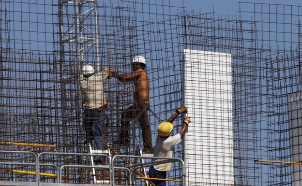 Workers work on the construction of an apartment building in Madrid. 