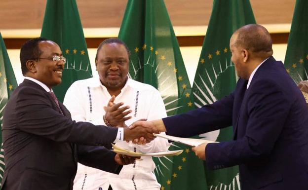 El expresidente de Kenia, Uhuru Kenyatta, aplaude al representante del Gobierno etíope, Redwan Hussien, y al delegado de Tigray, Getachew Reda, este miércoles en Pretoria, Sudáfrica.